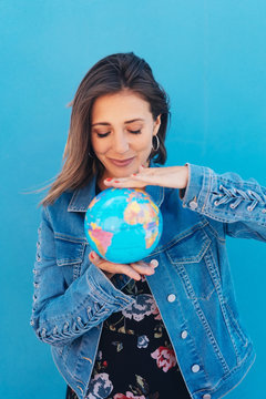 Young woman holding a globe between her hands