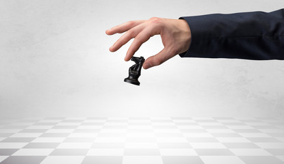Big elegant hand taking his next step on chess game
