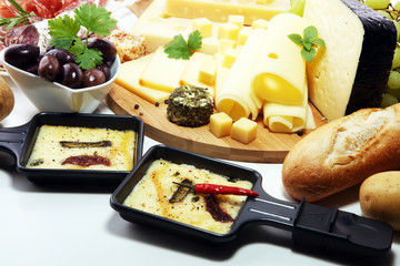 Delicious traditional Swiss melted raclette cheese on diced boiled or baked potato.