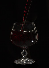 Glass still life image A glass of red wine in a glass on a black background