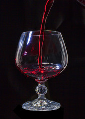 Glass still life image A glass of red wine in a glass on a black background
