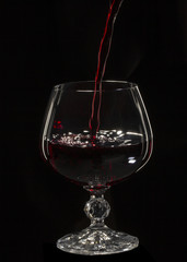 Glass still life image A glass of red wine in a glass on a black background