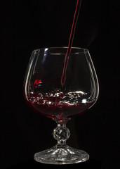 Glass still life image A glass of red wine in a glass on a black background