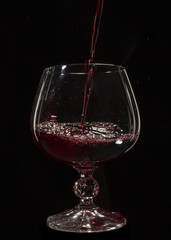 Glass still life image A glass of red wine in a glass on a black background