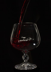 Glass still life image A glass of red wine in a glass on a black background