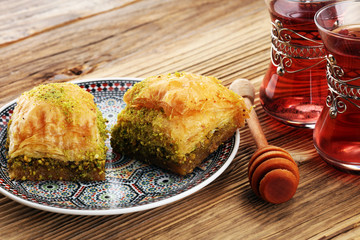 Turkish Dessert Baklava with pistachio on wooden table.