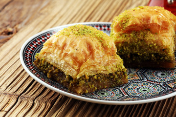 Turkish Dessert Baklava with pistachio on wooden table.