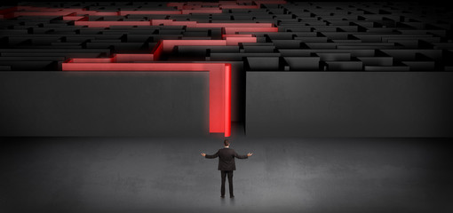 Businessman getting ready to enter the dark labyrinth with stated road concept
