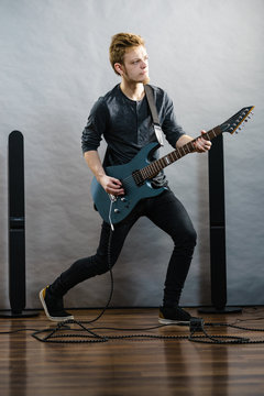 Young man playing electric guitar
