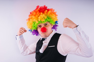 Office worker in clown wig, clown concept at work. Businessman with clown wig isolated on white