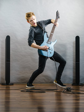 Young man playing electric guitar