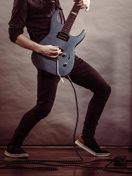 Male hands playing electric guitar