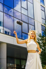 Cheerful fashionable woman in city