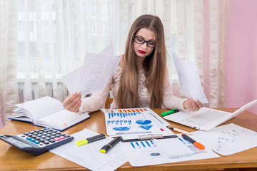 Financial analyst comparing business graphs, workplace, office