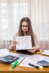 Woman looking through 1040 form preparing to fill