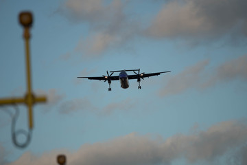 City Airport plane landing in the evening with tourists 