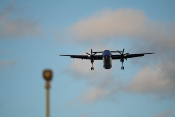 City Airport plane landing in the evening with tourists 