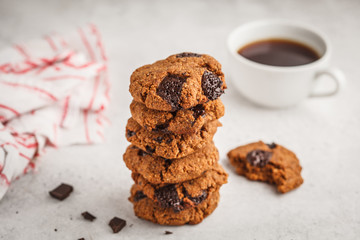 Stack of healthy vegan cookies with chocolate, white background. Clean eating concept.