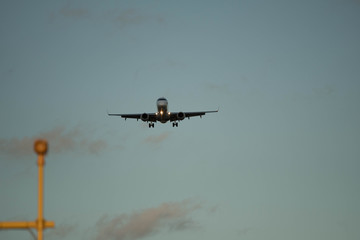 City Airport plane landing in the evening with tourists 