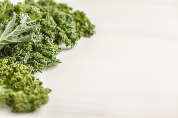Fresh green leaves of kale on white background.