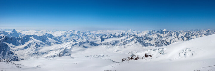 Fototapeta na wymiar Greater Caucasus mountains at winter sunny day. View from Pastuchova kliffs at Elbrus ski slope, Kabardino-Balkaria, Russia