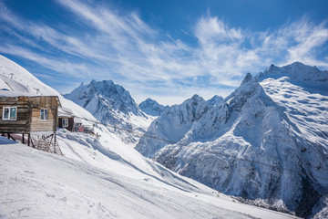 An old soviet cable car termina on a ski slope in winter sunny day. Dombay ski resort, Karachai-Cherkess, Western Caucasus, Russia.