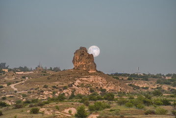 Moon over the canyon. Travel to Cappadocia. Goreme National Park.