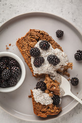 Chocolate vegan banana bread with chia pudding and blackberries, white background.