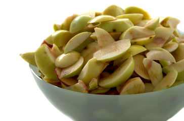 Apples sliced for drying. lie in the bowl,