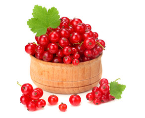 red currant in wooden bowl with green leaf isolated on white background. healthy food