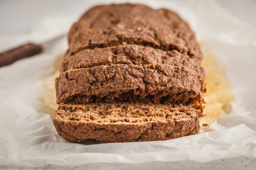Chocolate vegan zucchini bread, white background.