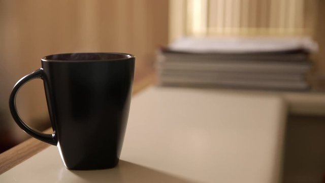 Hand Grabbing Mug with Steam 