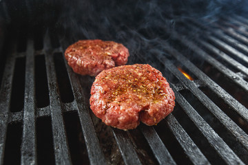 burger patties grilled on grill 