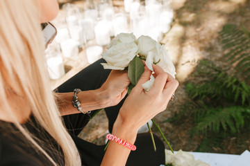 Hands Wedding Planner holding rose bouquet and talking phone