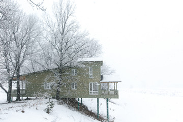 Wooden cottages in winter time, lake gateway 