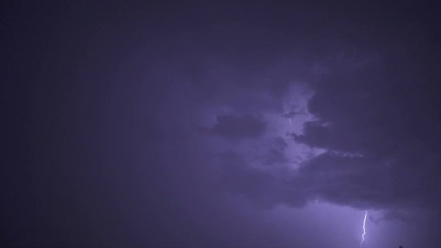The picturesque thunderstorm with lightning in the night sky. slow motion