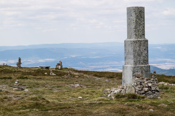 Stones stacked on top of a mountain. The summit in central europe.