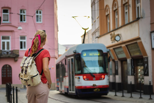 Tourist woman looking at passing tram in ancient city Olomouc, Czech Republic