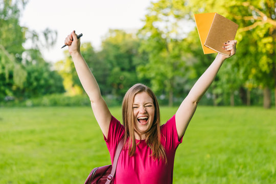 Very happy student girl with notes and backpack. Wow! Entering the university, starting school in September