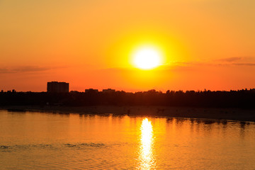 Orange sunset over a river Dnieper in Kremenchug city, Ukraine