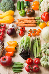 Assortment of fresh colorful organic vegetables on wooden pine table, creative food background in a grid, vertical, selective focus