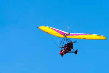 Glider high in the sky. Glider on a blue sky background.