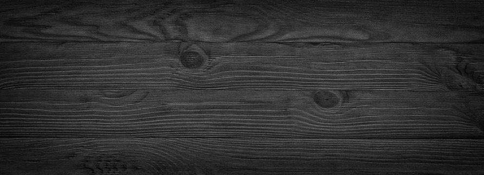 Panorama of black wooden boards, gloomy wood texture, dark background
