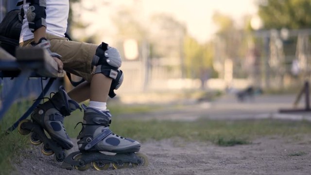 Legs of a child in roller skates. The child rolls on rollers.