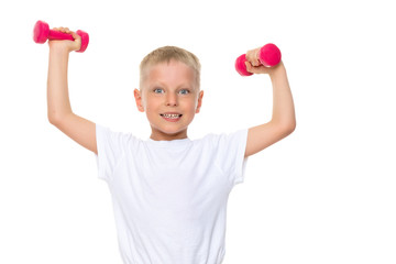 A little boy is lifting dumbbells.