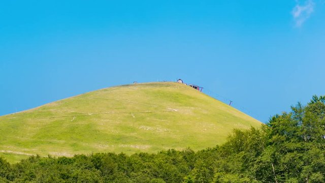 Mountains in summertime landscape blue sky and clouds, Terminillo Italy time lapse panning left to right