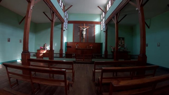 Abandoned Humberstone and Santa Laura saltpeter works factory, near Iquique, northern Chile, South America. Walking inside church towards altar with Jesus statue.