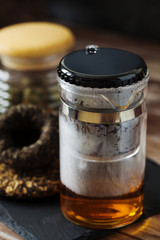 Hot Chinese Pu-erh Tea pot on a black slate board