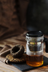 Hot Chinese Pu-erh Tea pot on a black slate board
