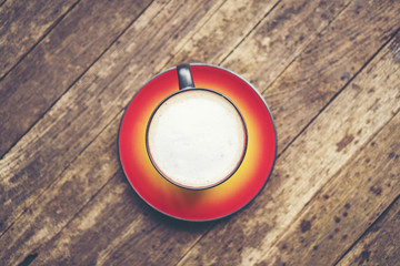coffee latte art in red cup, vintage filter image